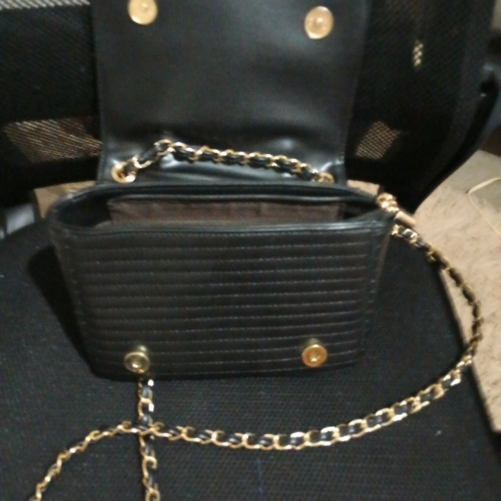 Random designer. Very unique style. The purse is shaped like a leather jacket.